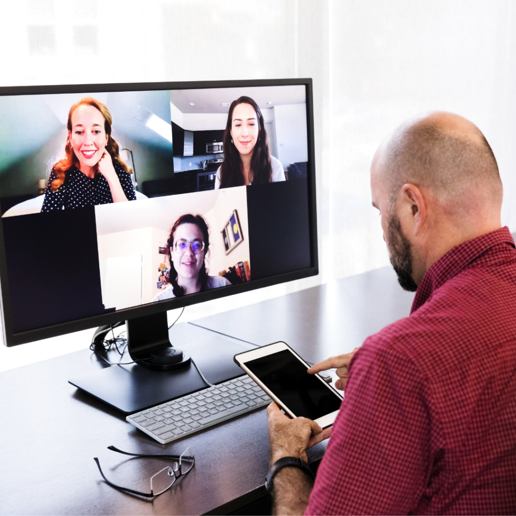 Image shows a man voting on his phone while in a virtual meeting.